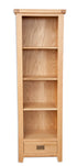 Melbourne Natural Oak slim bookshelf with a drawer on a white background. Available from A Quirky Corner Banbury