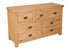 Melbourne Natural Oak 7-drawer wide chest on a white background. Available from A Quirky Corner Banbury.